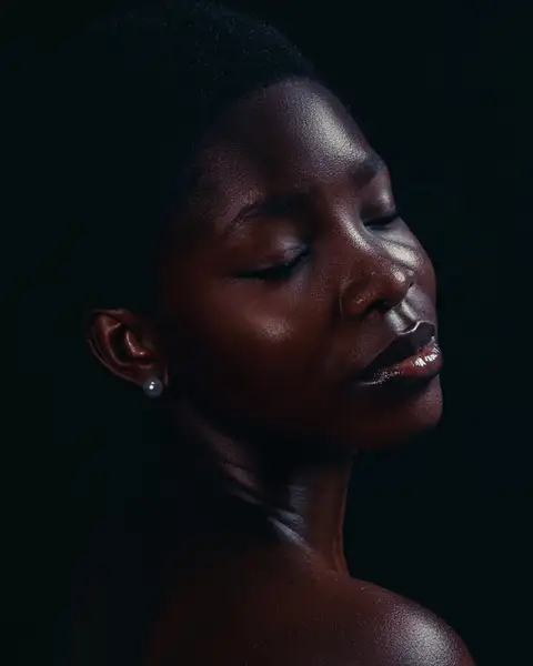 Sample frame: Woman with eyes closed against a dark background