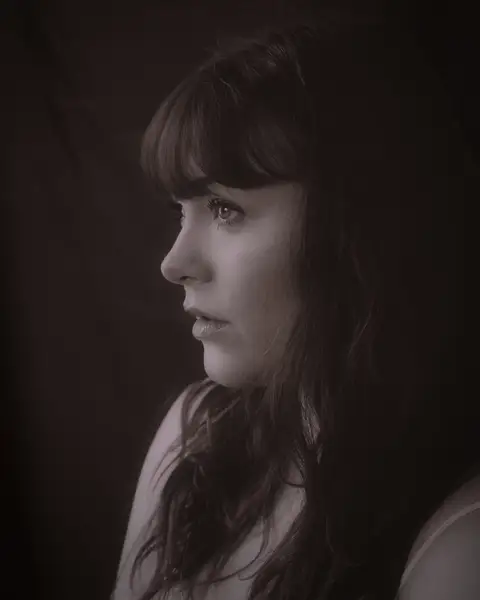 Sample frame: Side profile portrait of a woman in warm light